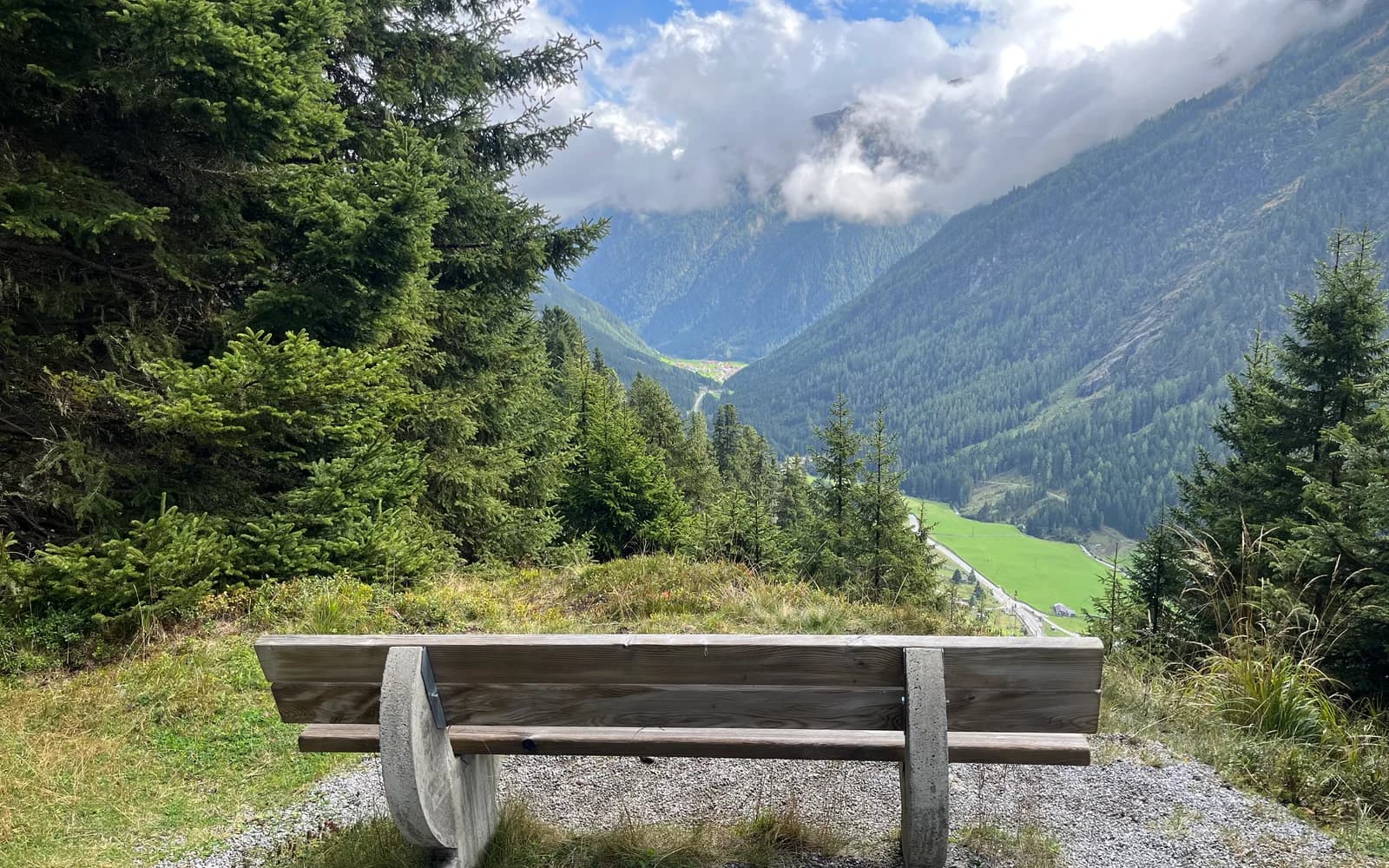 Ruhige Bank mit Blick in die Tiroler Berge als Symbol für persönliche Begleitung